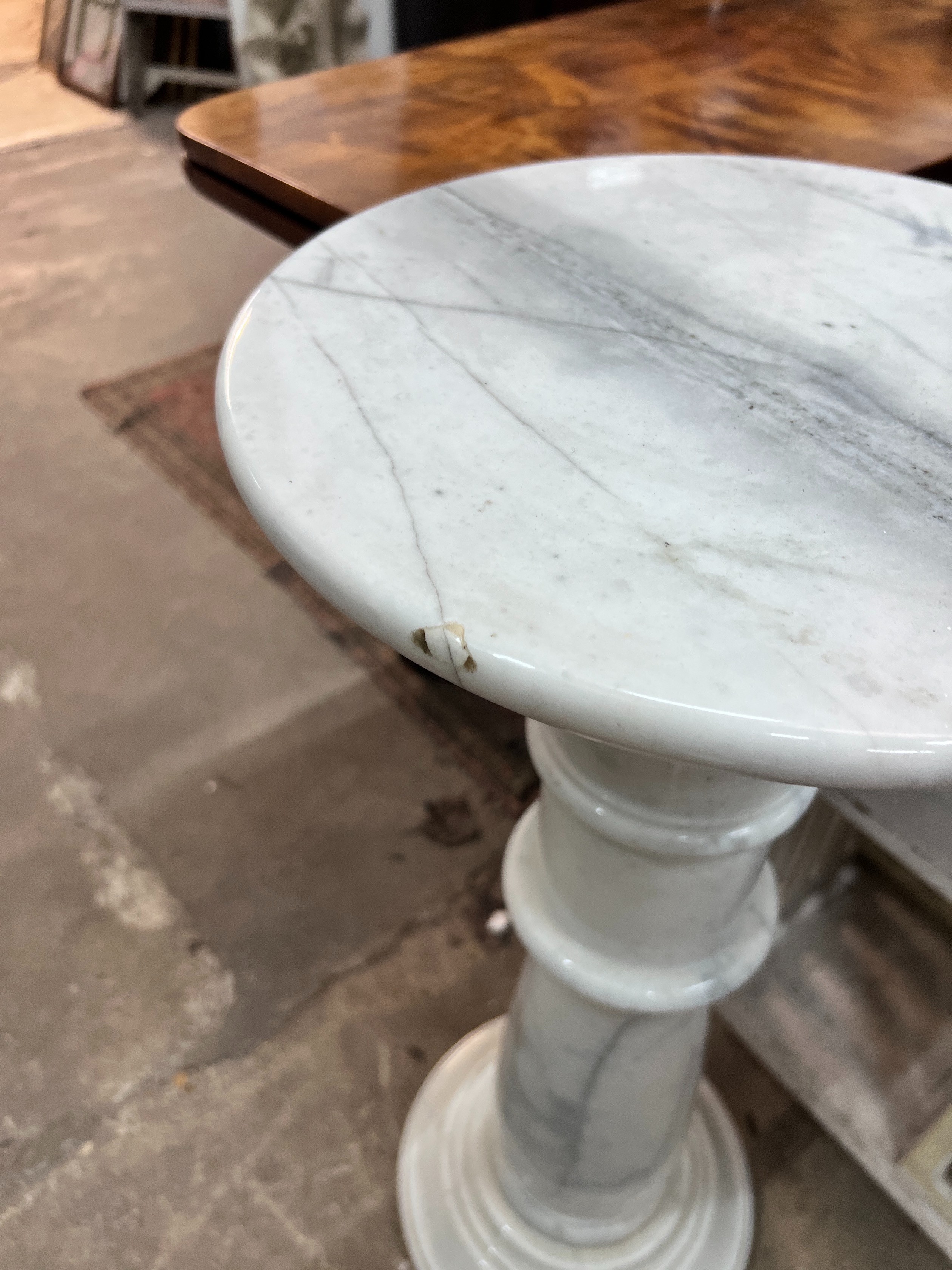 A circular marble pedestal, diameter 35cm, height 80cm *Please note the sale commences at 9am.